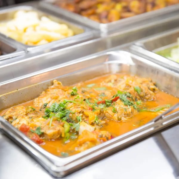Brazilian moqueca, a fish stew with cilantro and peppers, in a buffet tray at Pampas Grill.